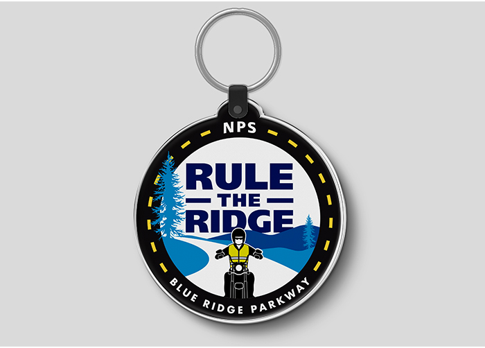 Custom logo shown on a keychain, graphics include a motocyclist on a mountain road.