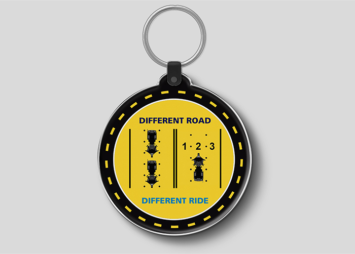 Reverse side of the keychain with a graphic showing proper road position for motorcyclists.