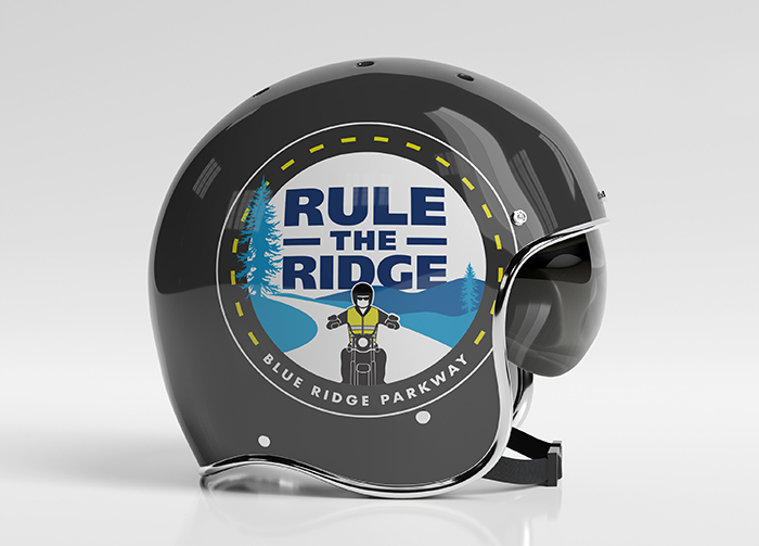Custom logo shown on the side of a motorcycle helmet, graphics include a motocyclist on a mountain road.