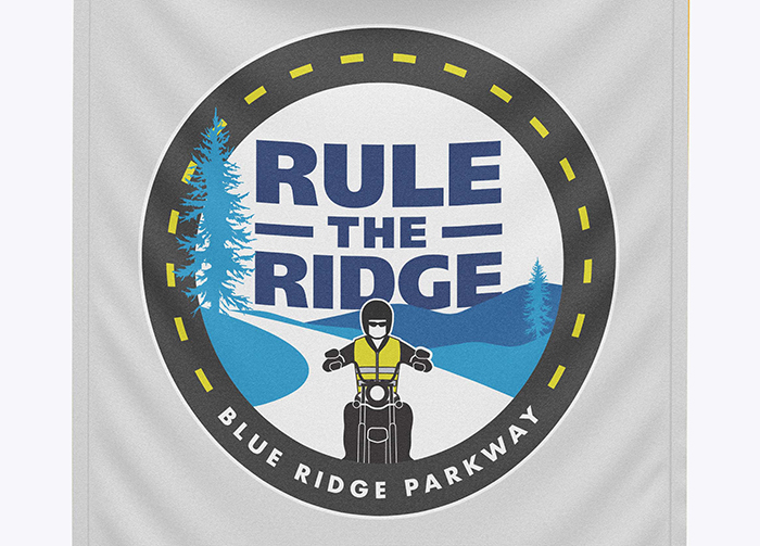 Custom logo graphics include a motocyclist on a mountain road.